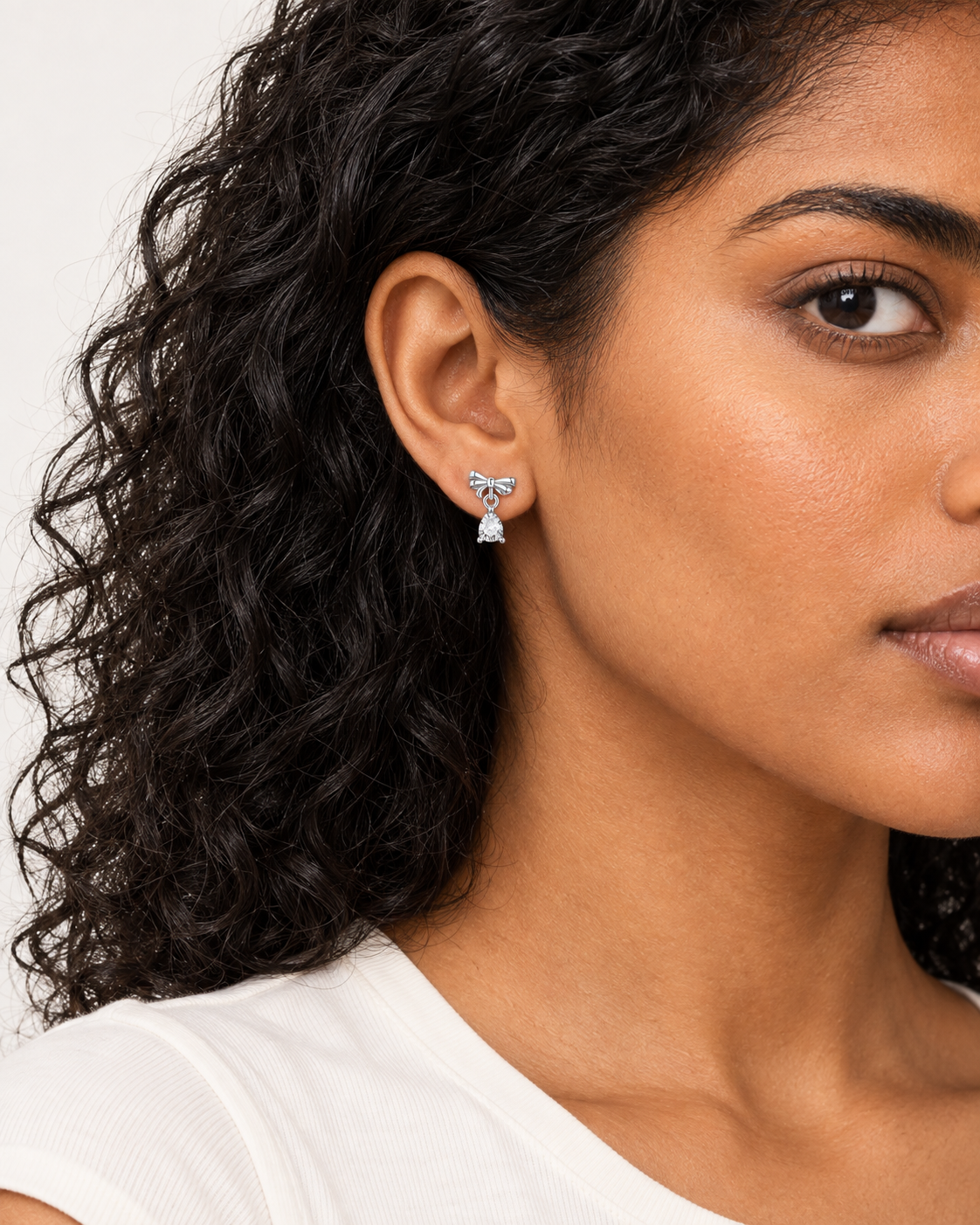 Bow Pear Drop Earrings — worn close view