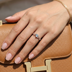 Sculptural rose gold plated heart ring showcasing an asymmetric cluster of baguette and round diamonds.