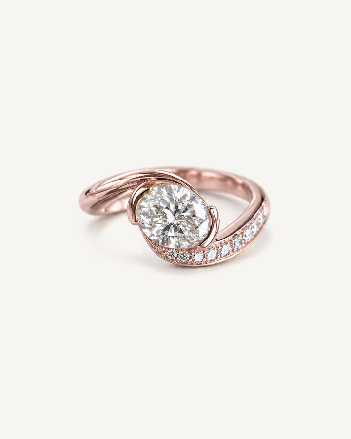 Swirl Solitaire Ring in rose gold with a round centre diamond and curved diamond-set band