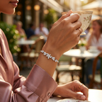 A woman enjoying a cup of coffee while showing the Marquise Vine bracelet on her wrist, highlighting the elegant, everyday wear style of the brilliant lab grown diamonds.