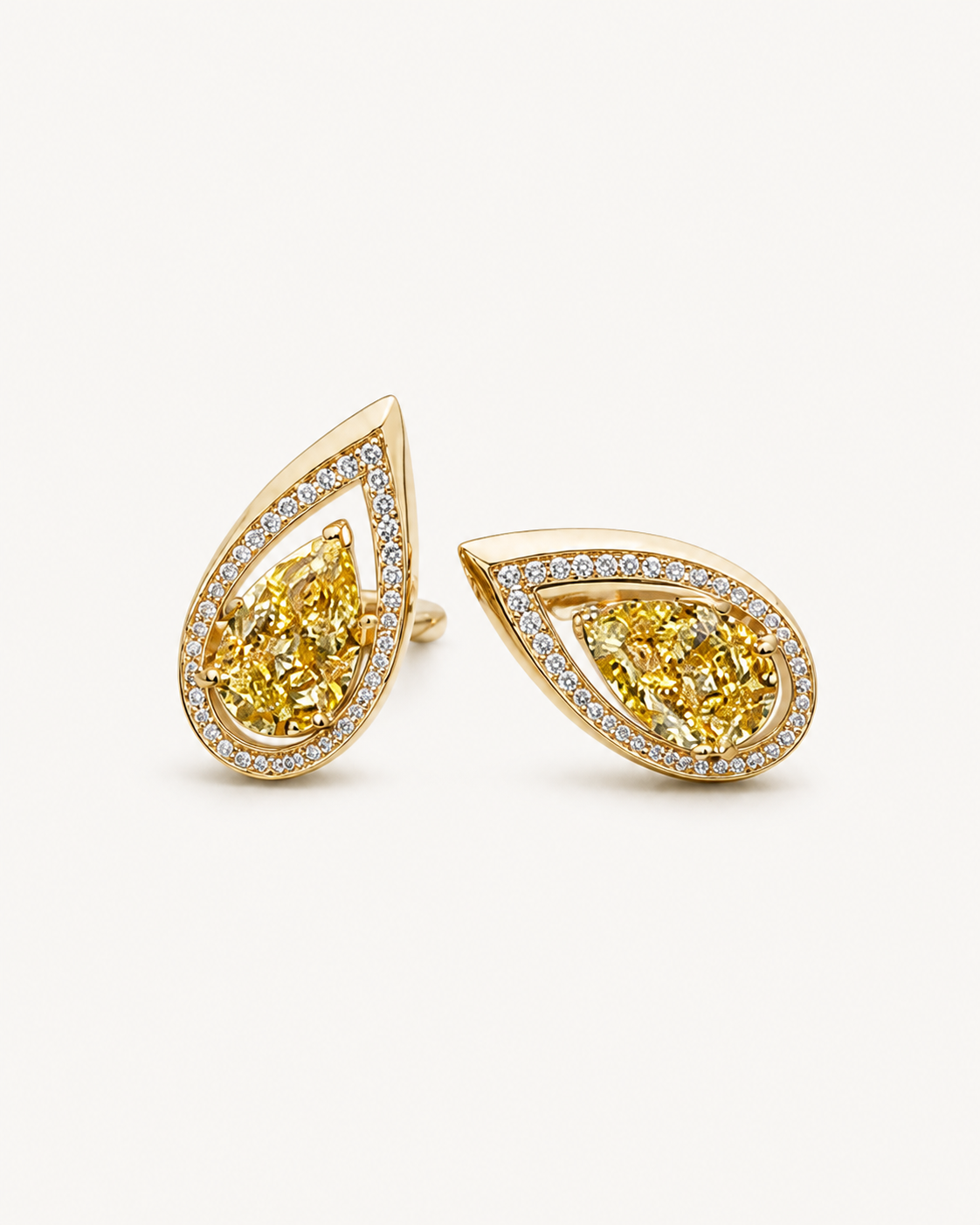 Warm-metal yellow pear stud earrings on Oyster Silk.